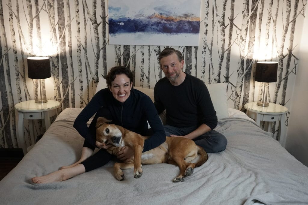 Jennifer Byrne, left, and Timothy Goodwin at home with their dog, Awesome.Credit...Timothy C. Goodwin